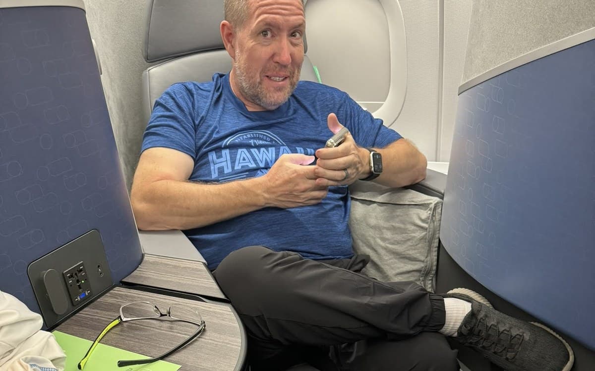 Jim relaxing in a lie-flat business class seat