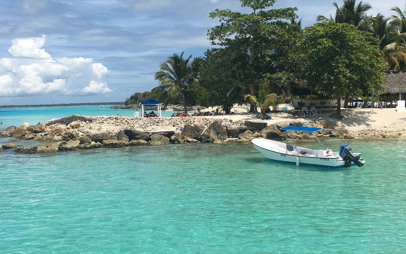 A boat on clear turquoise water in the Dominican Republic